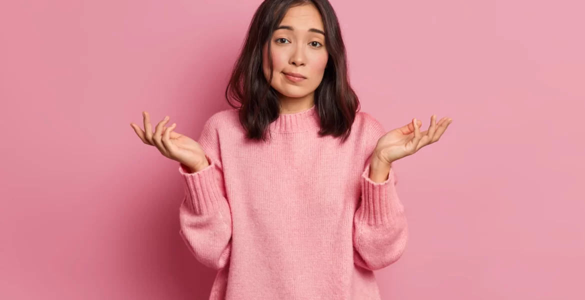 life-perception-hard-decision-concept-puzzled-clueless-young-asian-woman-spreads-palms-poses-uncertian-indoor-expresses-doubt-wears-knitted-sweater